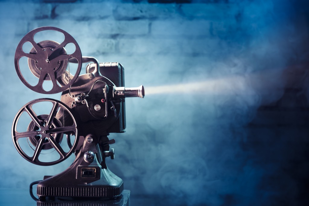 cinema_old film projector with dramatic lighting